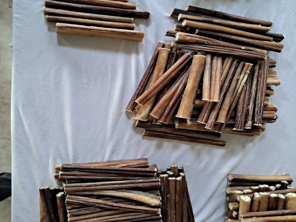 Bully sticks sorted into grades on a white cloth